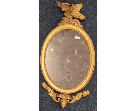 Regency mirror fitted with eagle finial and wreath base form. Oval shaped mirror. Needs attention. 