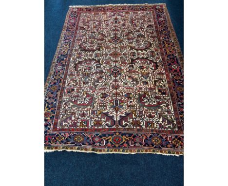 Large Persian hand knotted rug. Shows four signatures- see images. 330x236cm. 