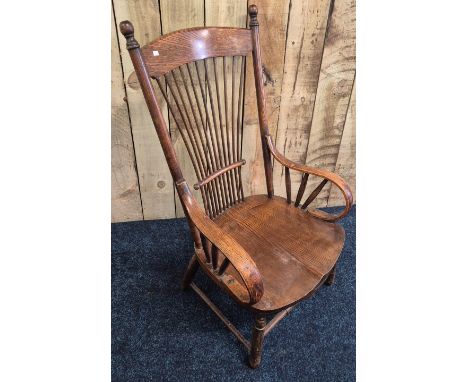 Antique oak and elm wood arm chair. Legs shortened. 101cm in height. 