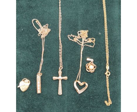 Selection of 9ct yellow gold jewellery; Heart and key charm. Cross pendant and chain, heart pendant and chain. pearl swirl pe