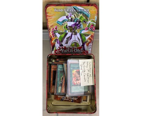 Tin containing a collection of 1996 1st edition Yu- Gi- Oh! trading cards. 