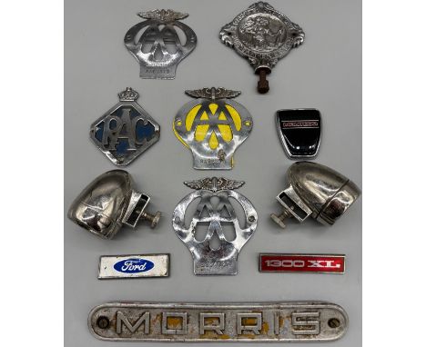 Collection of various car badges; Ford badge, various AA badges, RAC badge, Morris badge, Montego badge and others.