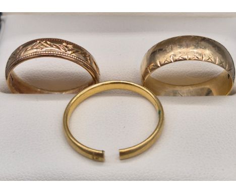 Three gold band rings; Two 9ct yellow gold band rings - ring size R. 7.45grams. Together with 18ct yellow gold band ring- dam