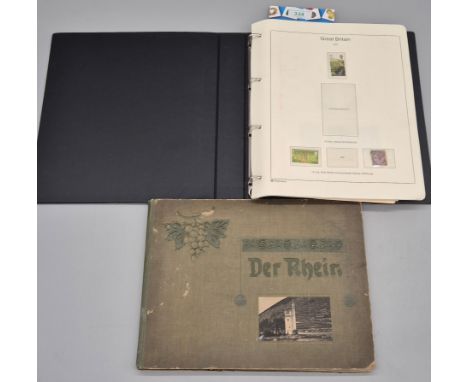 Stamp album with stamps and German picture book showing various landmarks. 