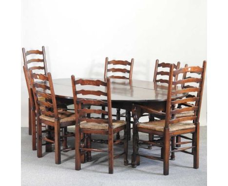 An 18th century style hand made oak wakes table, together with a set of eight rush seated ladder back dining chairs (9)262 x 