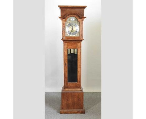 A modern bespoke made oak cased longcase clock, having an arched brass dial, with Westminster chimes214cm high