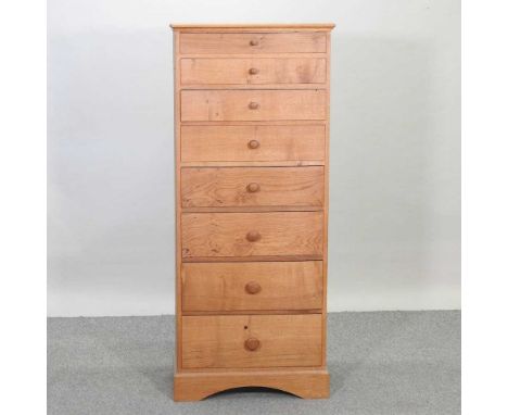 A modern light oak narrow chest, containing eight graduated drawers64w x 39d x 152h cm