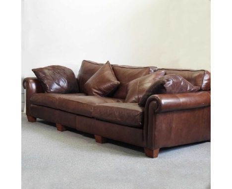 A large brown leather Duresta sofa, with loose cushions, together with an upholstered footstool (2)275w x 126d x 88h cmCondit