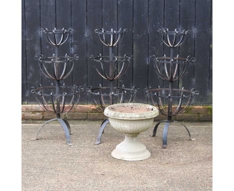 Three black painted metal three tier garden planters, together with a reconstituted stone garden planter (4)Three tier plante