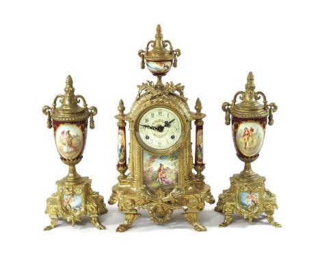 An ornate French style brass three piece clock garniture, 20th century, having a painted dial and inset with painted porcelai