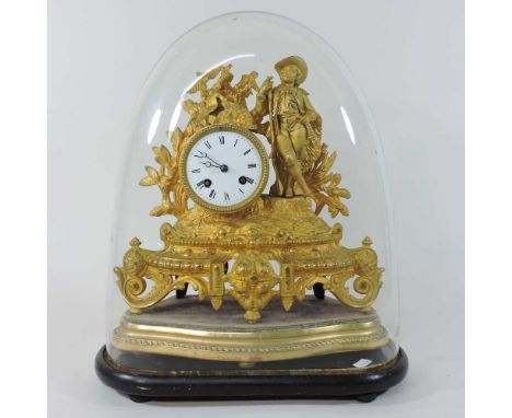 A 19th century French gilt metal figural mantel clock, with a white enamel dial, on a scrolled base, contained under a glass 