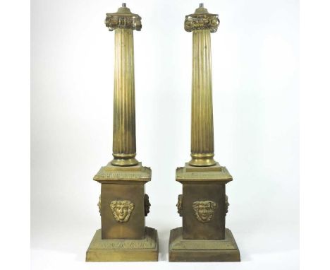 A pair of 19th century brass table lamps, of architectural form, with a fluted column, with mask decoration58cm highCondition