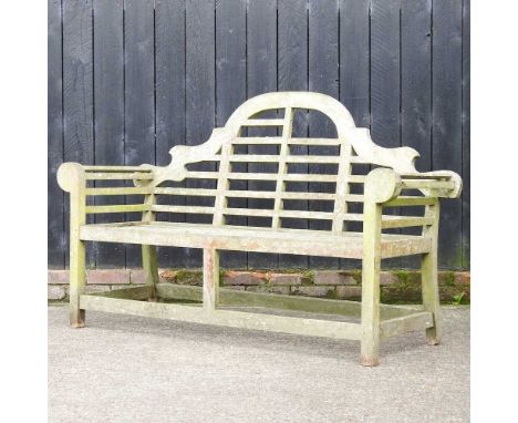 A hardwood slatted garden bench, with a shaped back165w x 57d x 103h cm