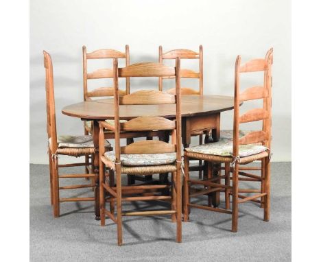 A set of six 19th century elm rush seated ladder back dining chairs, to include two carvers, together with a 1920's oak gatel