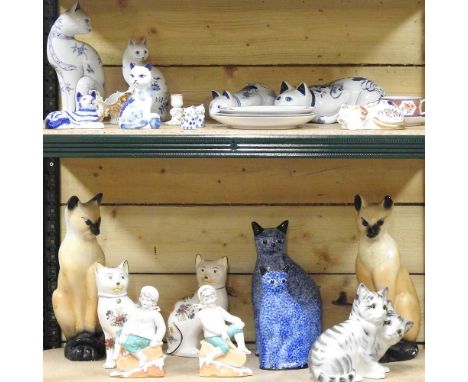 A collection of pottery models of cats, to include a Staffordshire pottery figure group of two grey catsStaffordshire figure 