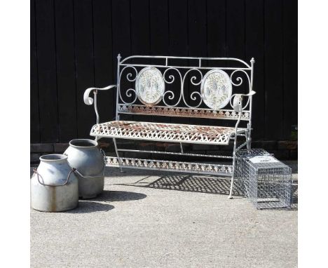 An iron painted garden bench, later 20th century, together with a pair of steel milk containers, a steel animal cage, a galva