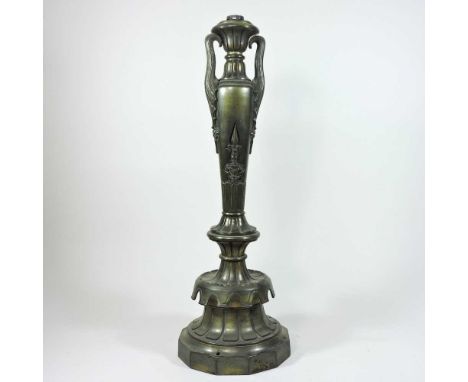 A late 19th century heavy brass table lamp, of slender urn form, on a shaped base55cm high