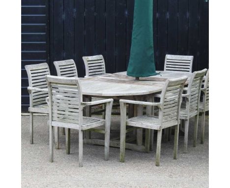 An extending hardwood garden table, 250 x 120cm overall, together with a set of eight chairs, and a folding parasol with cove