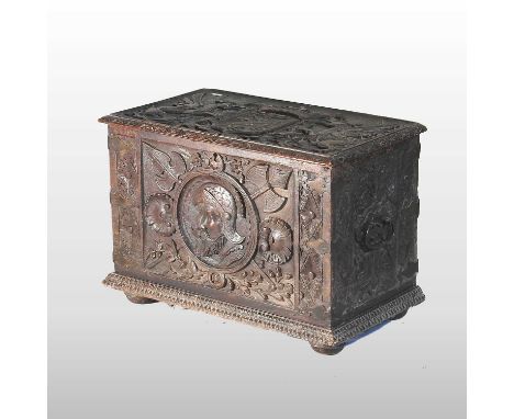 An 18th century carved oak coal box, the hinged lid decorated with a heraldic crest and a portrait medallion to the front56w 
