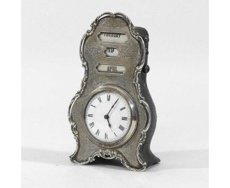 An Edwardian silver desk/clock calendar, the engraved shaped case, inset with calendar above a white enamel clock dial, with 