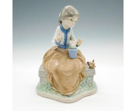 Glossy figural with birds and flowers. Tan and blue coloration. Nao by Lladro backstamp. This item has its original box: 9"L 