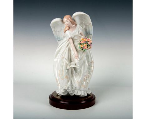 Retired figurine with a glossy finish and Lladro backstamp on bottom. The round wooden base measures 7.25"dia. x 1.25"H. This