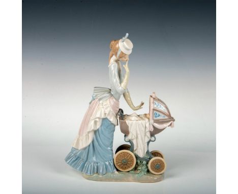 A figure of a Victorian woman in a blue dress taking her baby on a stroll in their carriage. Lladro backstamp. This item has 