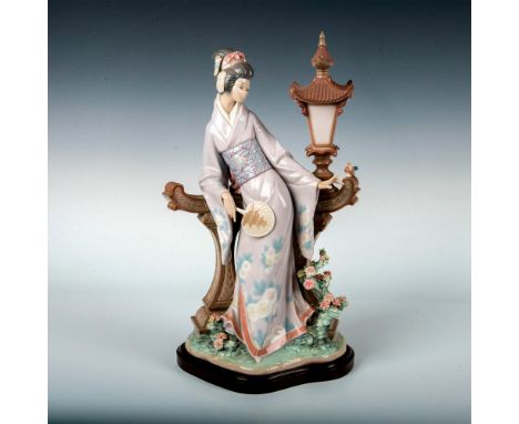 Glossy finish porcelain figure modeled Woman dressed in traditional Japanese attire next to lamp post. Lladro backstamp. This