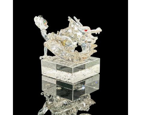 Lead crystal 1st generation zodiac dragon in a crystal silver shade with red crystal eyes atop a clear crystal base which fea