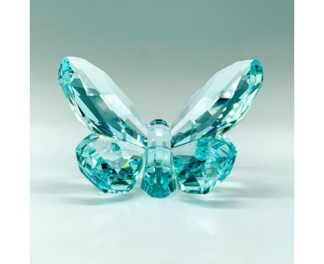 A light blue crystal figure of a butterfly at rest with open wings. Swarovski backstamp. This item has its original box. Dime