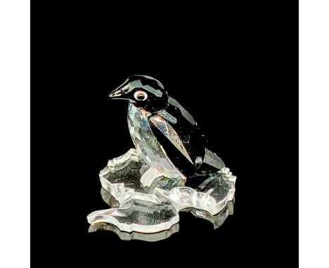 This retired Swarovski penguin is made from clear and black crystal, has white crystal around its eyes, frosted feet and come
