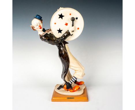 This figurine features aÂ&nbsp; fun-loving clown playing the drum standing on a square wooden base. Giuseppe Armani golden pl