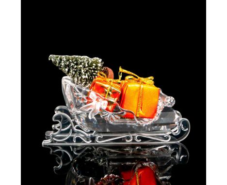 Lead crystal part of the Exquisite Accents series and comes with two wrapped presents and a small tree. Swarovski etched back