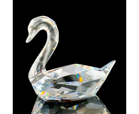 A pure clear crystal swan with different cuts throughout the body in a seated position with the tail pointed out. Swarovski b