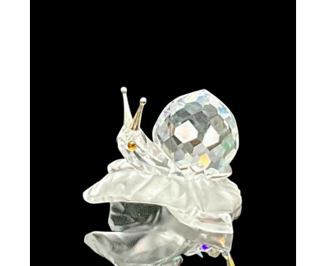 Part of the Among Flowers and Foliage grouping. A crystal clear body of the snail with metal antenna. The snail is resting on