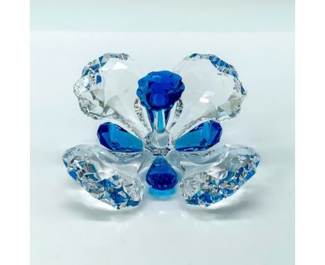 A clear crystal figure of a flower with blue crystals used for the accents of the flower. Swarovski backstamp. This item has 