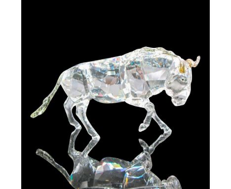 Elegantly crafted faceted crystal charging gnu or wildebeest figurine. Smoky quartz horns, mane, and tail details. Part of th