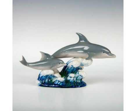 Retired figurine of an adult and baby dolphin with a glossy finish and Lladro backstamp on bottom. This item has its original