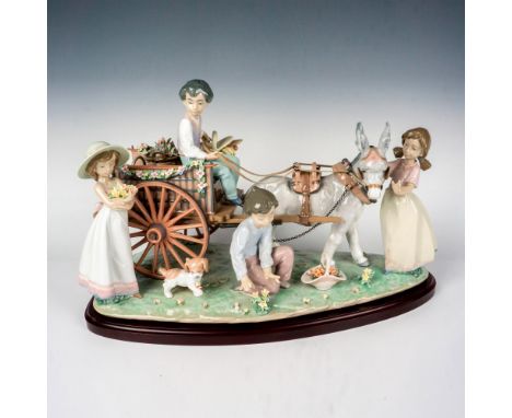 Gorgeous limited edition glossy figural grouping featuring four young people and their dog around a flower-adorned donkey car