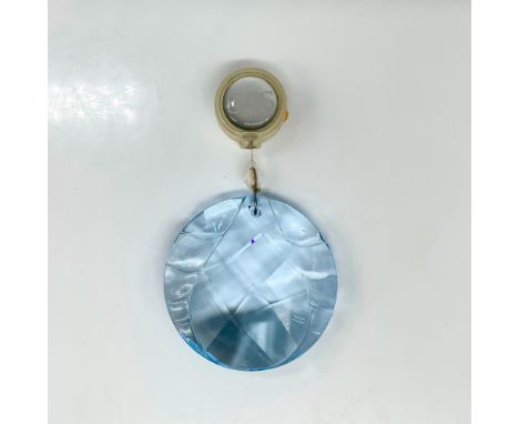 A blue round crystal ornament with a tear drop carved into the center. Swarovski backstamp. This item has its original box. D