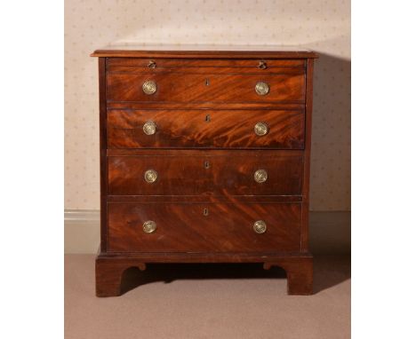 A George III mahogany bedside commode, modelled as a chest of drawers, circa 1800, the hinged rectangular top lifting togethe