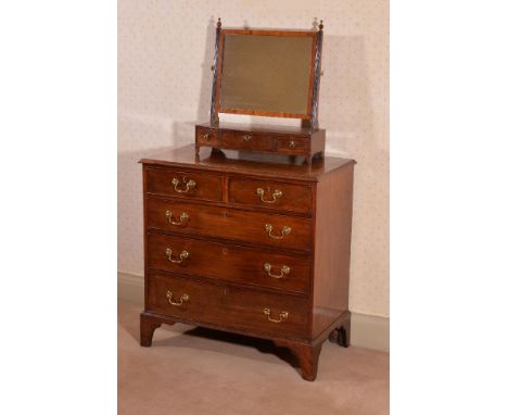 A George III mahogany chest of drawers, circa 1780, the rectangular top with moulded edge, above two short and three long gra