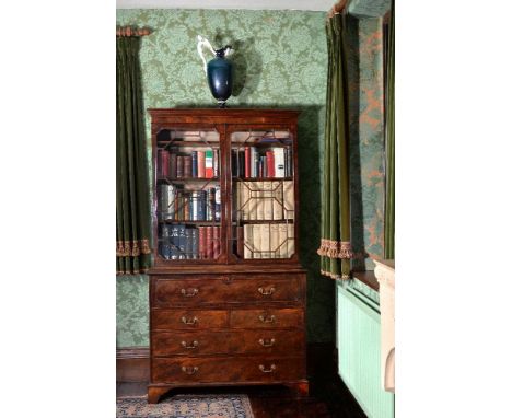 A George III mahogany secretaire bookcase, circa 1790, the moulded cornice above a pair of astragal glazed doors, opening to 