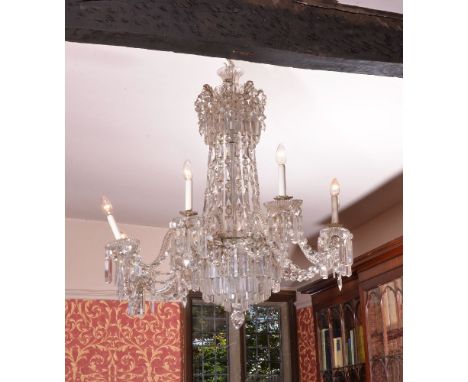 A cut glass eight light chandelier in late George III style, 20th century, the electrical fitments in drip pans on scrolling 