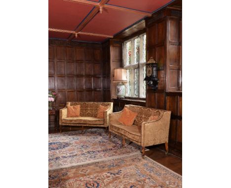 A George III beech and upholstered sofa, paired with another of later date, each padded rectangular back above a loose cushio