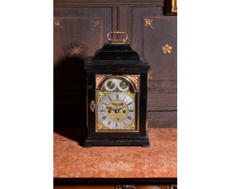 A George I gilt metal mounted ebonised table clock, James Snelling, London, circa 1725, the five finned pillar twin fusee bel