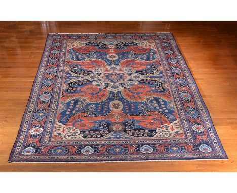 An Ardebil carpet, the central cream medallion surrounded by reserves of flowers in blue and red, within similarly decorated 