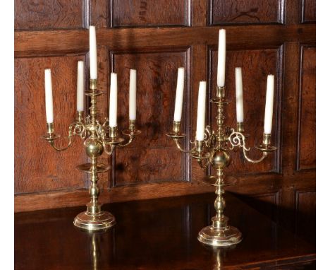 A pair of gilt metal five light candelabra in Dutch early 18th century style, 20th century, both with raised central sconces 