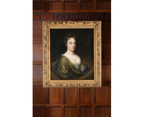 Circle of Sir Godfrey Kneller (British 1646 - 1723) Portrait of a lady with a green cloak Oil on canvas, feigned oval, carved