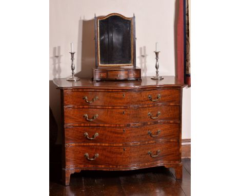 A George III mahogany serpentine fronted dressing chest of drawers, circa 1800, the shaped top with moulded edge above four l
